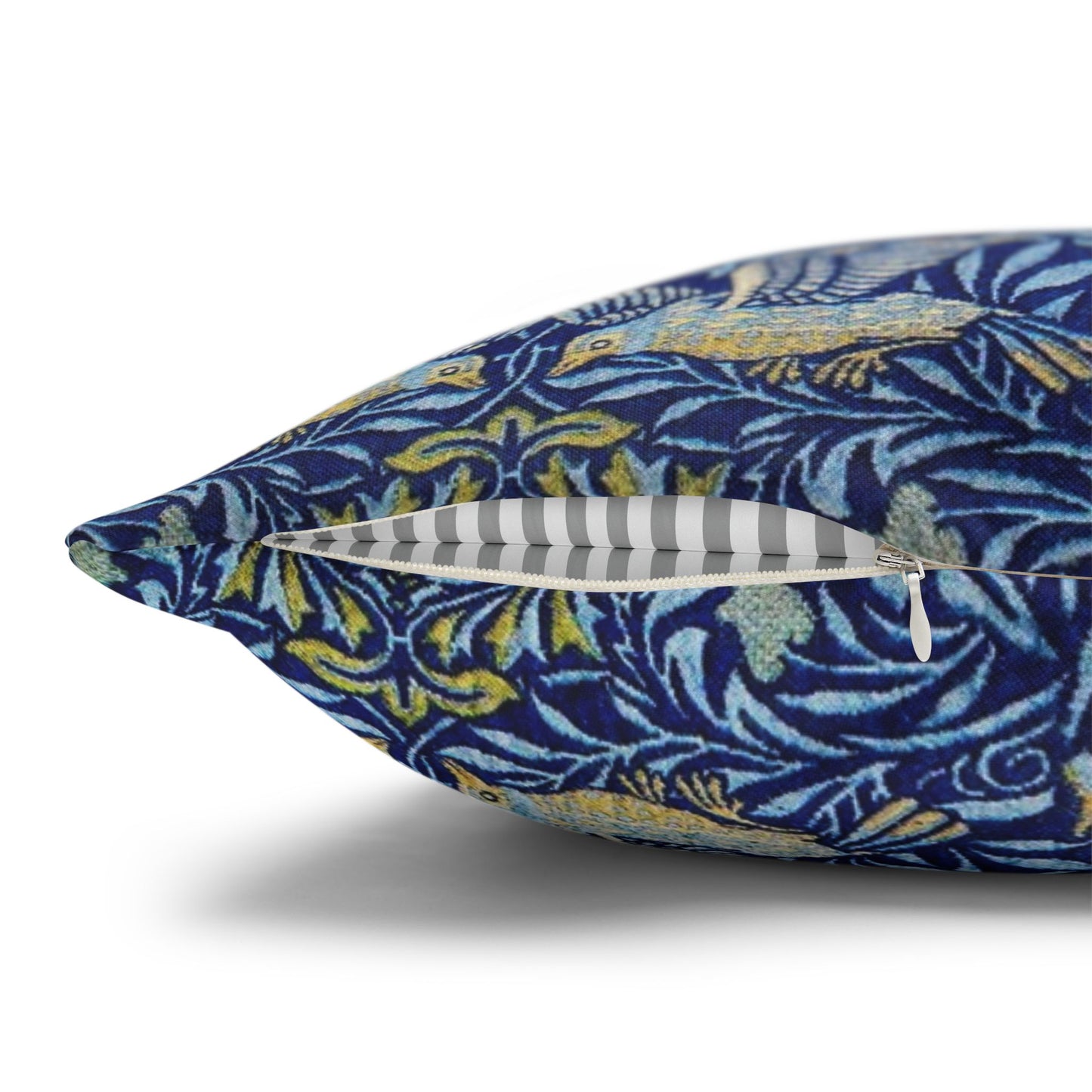 Decorative pillow with blue and yellow leaf pattern on a white background