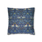 Decorative pillow with a blue pattern featuring birds and floral elements on a white background
