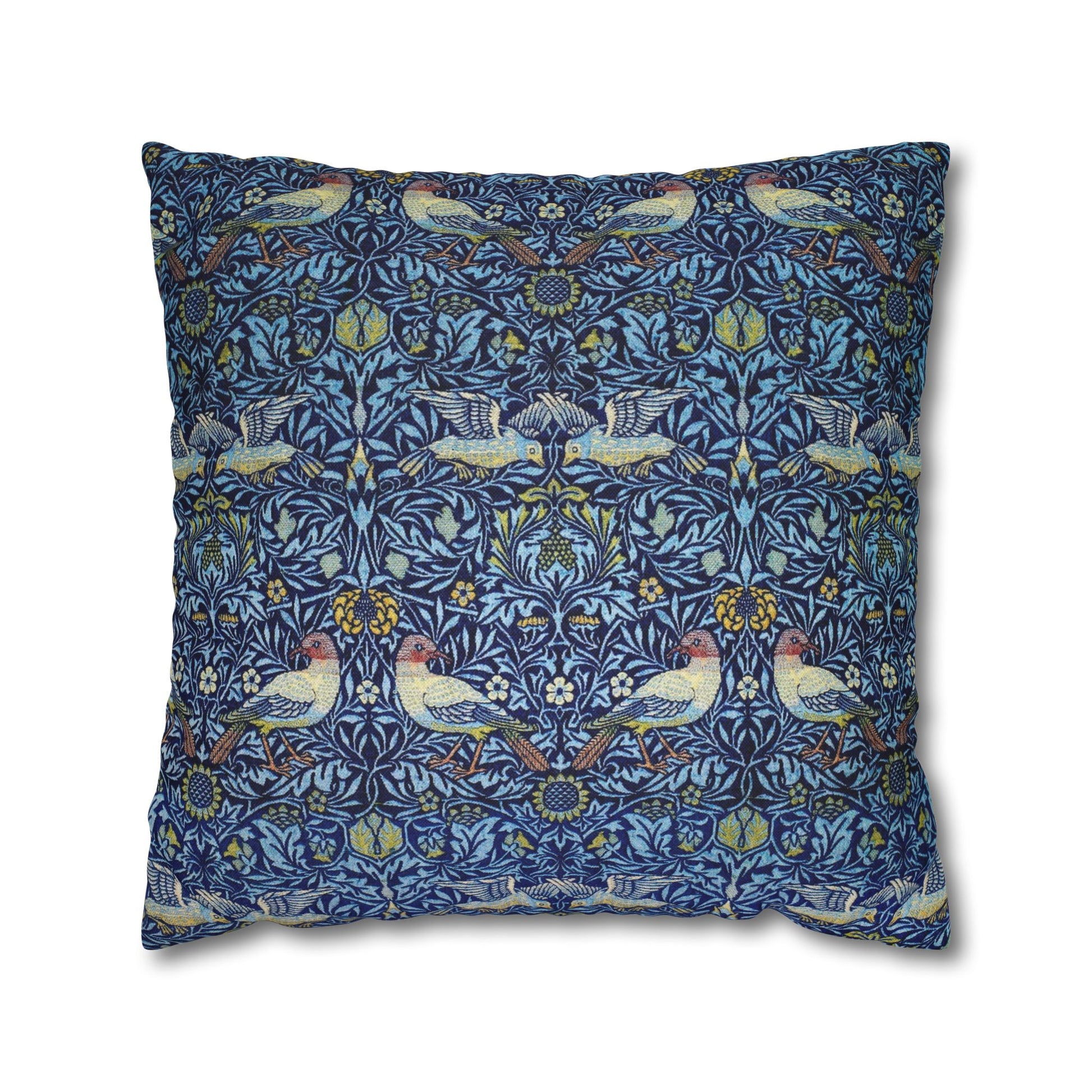 Decorative pillow with a blue pattern featuring birds and floral elements on a white background