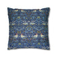 Decorative pillow with a blue pattern featuring birds and flowers on a white background
