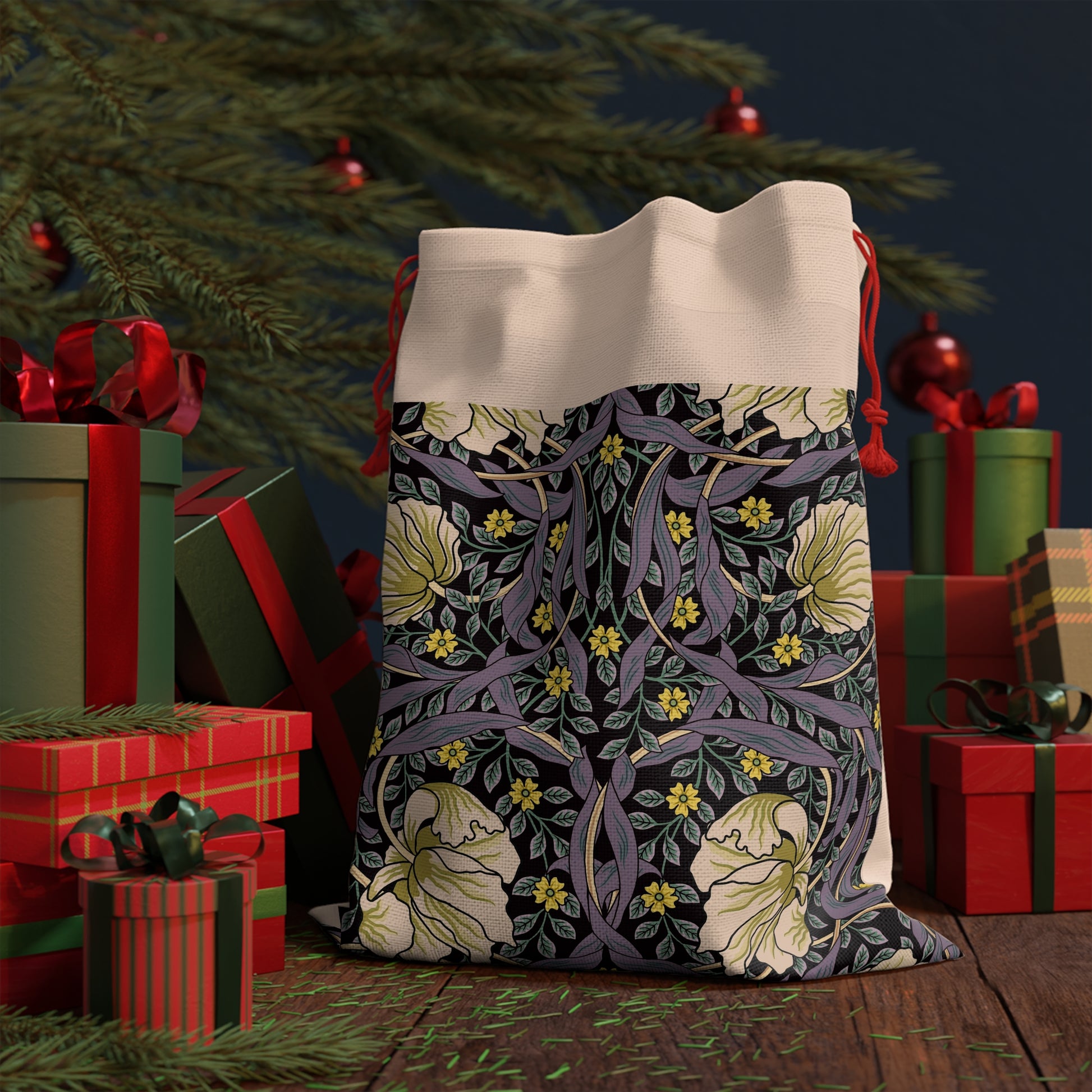 A rectangular Christmas-themed linen drawstring bag with a floral pattern, primarily in purple and green colours, and a red drawstring at the top.