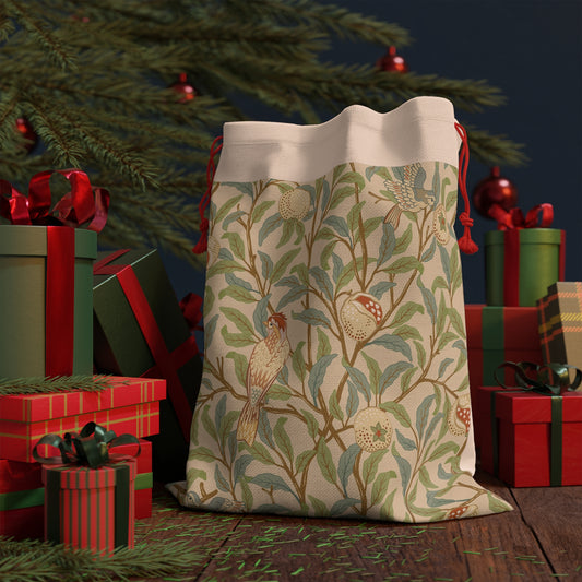 A Christmas Santa sack with a parchment colour, featuring a bird and pomegranate design inspired by William Morris & Co.