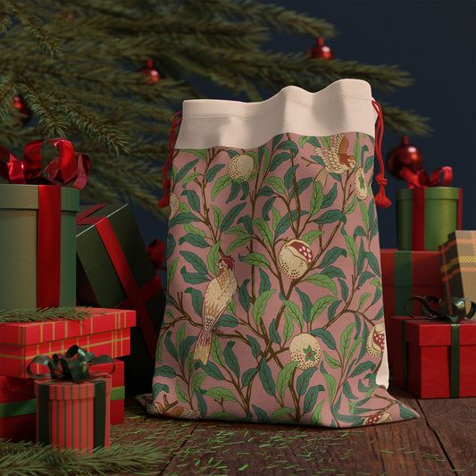 A rectangular Christmas Santa Sack with a pattern of birds and pomegranates in red, green, and beige colours, and red drawstrings.