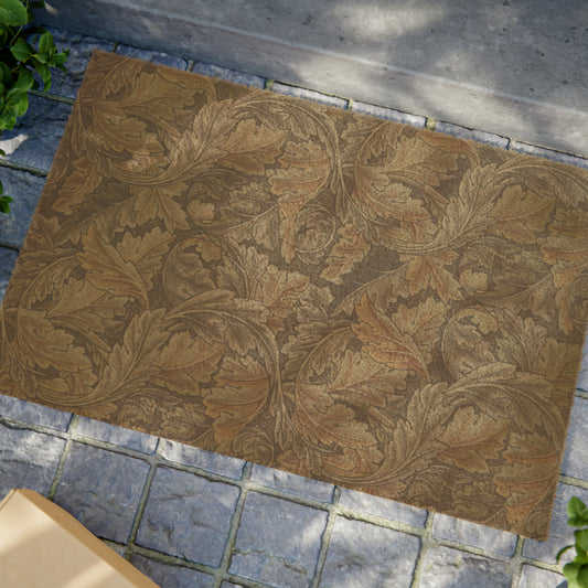 A rectangular doormat with an intricate grey pattern inspired by William Morris's designs, featuring a leaf motif. The doormat has a coarse texture and a black vinyl backing.