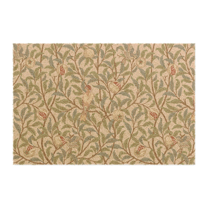 A rectangular coconut coir doormat with an intricate William Morris-inspired bird and pomegranate pattern in a parchment color.