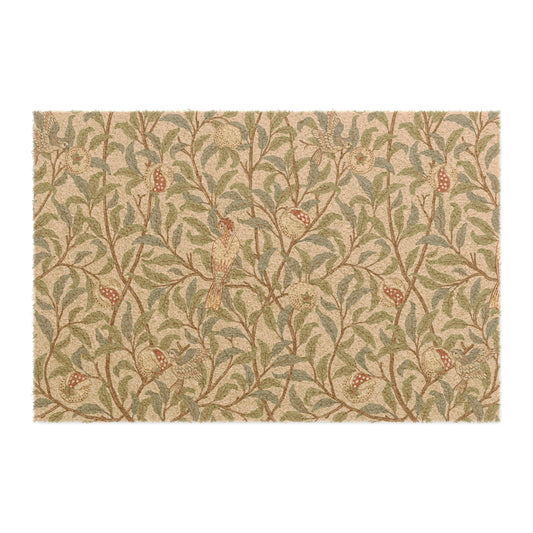 A rectangular coconut coir doormat with an intricate William Morris-inspired bird and pomegranate pattern in a parchment color.