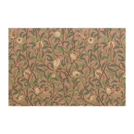 A rectangular coconut coir doormat with an intricate William Morris-inspired bird and pomegranate pattern in rosewood colour.
