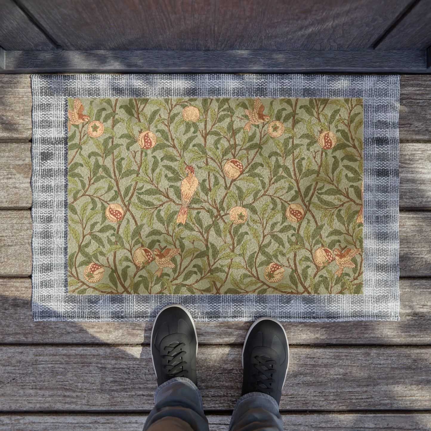 A rectangular coconut coir doormat with an intricate William Morris-inspired bird and pomegranate design in tiffany blue and green colours.