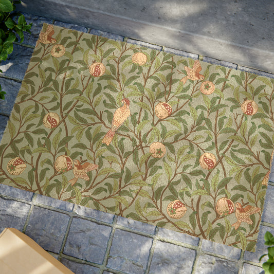 A rectangular coconut coir doormat with an intricate William Morris-inspired bird and pomegranate design in tiffany blue and green colours.
