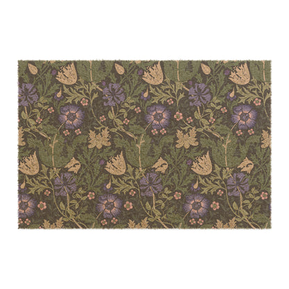A rectangular coconut coir doormat with an intricate floral pattern in shades of purple, green, and beige, featuring a tufted coir coconut fiber texture and a black vinyl backing.