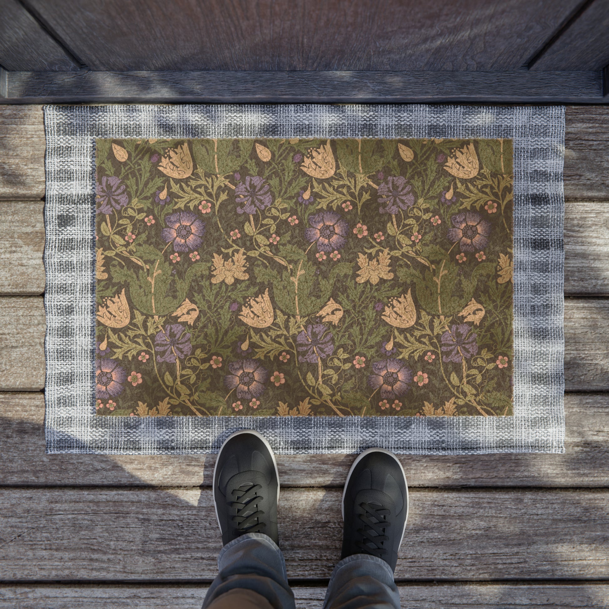 A rectangular coconut coir doormat with an intricate floral pattern in shades of purple, green, and beige, featuring a tufted coir coconut fiber texture and a black vinyl backing.