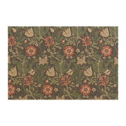 A rectangular coconut coir doormat with a floral pattern inspired by William Morris's designs, featuring a green background with multi-coloured flowers.