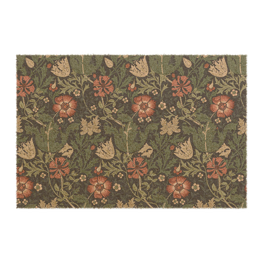 A rectangular coconut coir doormat with a floral pattern inspired by William Morris's designs, featuring a green background with multi-coloured flowers.