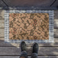 A rectangular coconut coir doormat with a floral William Morris & Co pattern in shades of brown and black.