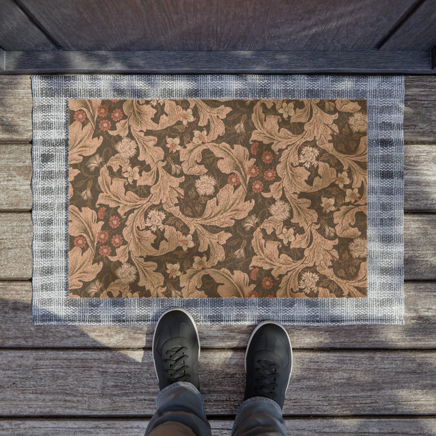 A rectangular coconut coir doormat with a floral William Morris & Co pattern in shades of brown and black.