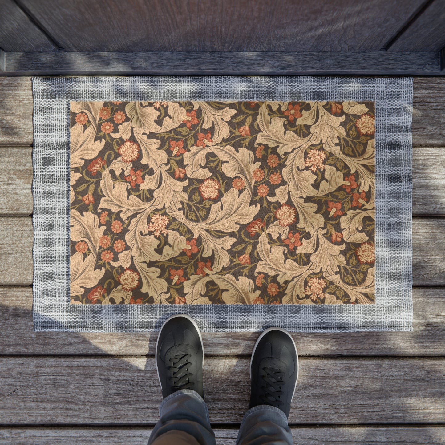 A rectangular coconut coir doormat with a floral pattern inspired by William Morris, featuring a mix of brown, beige, and green colours.