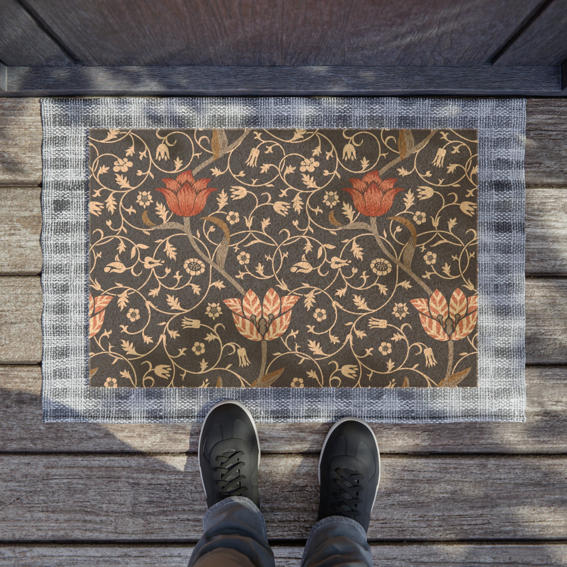 A rectangular coconut coir doormat with an intricate floral William Morris & Co pattern design, featuring a combination of dark and lighter shades, and a visible brush border at the top.