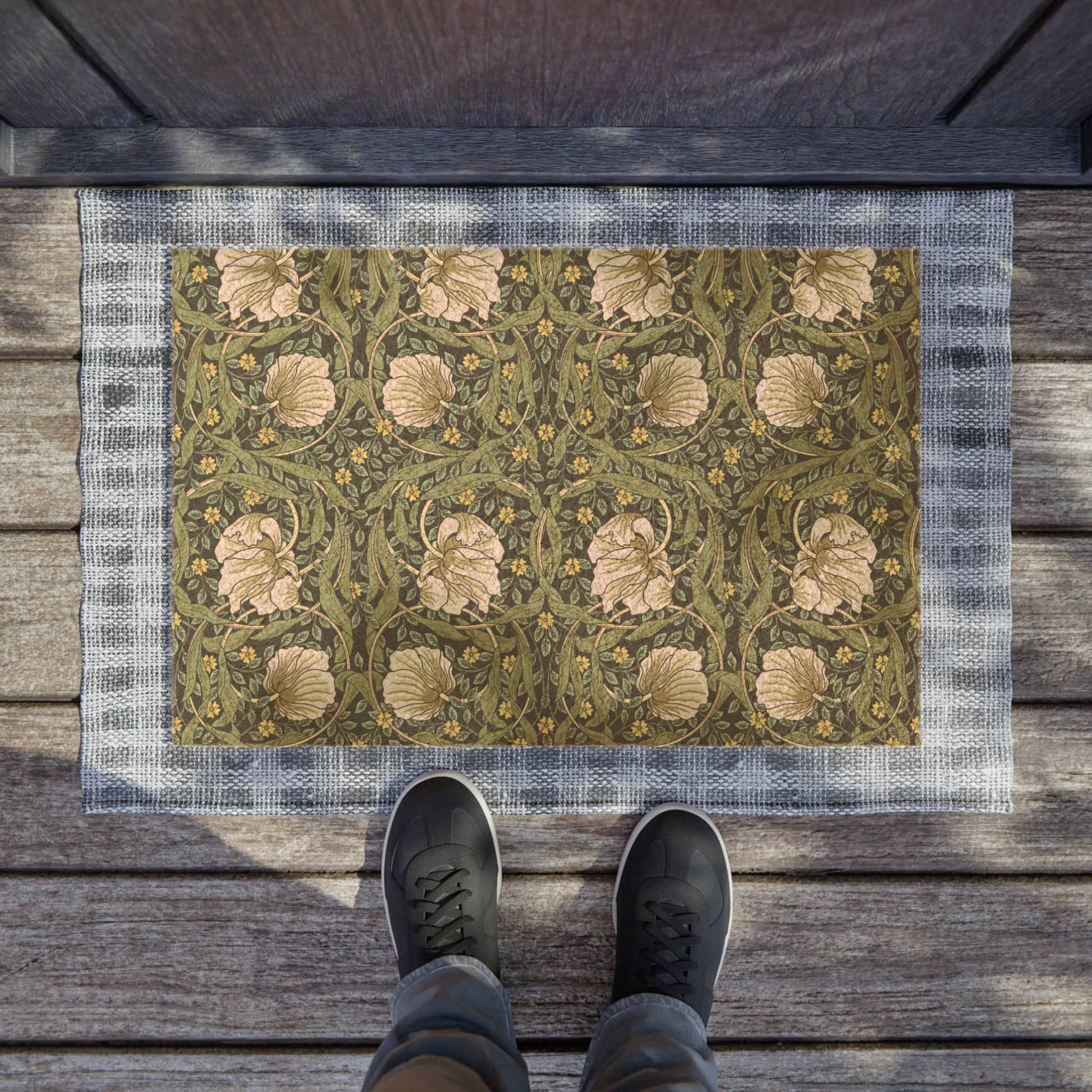 A rectangular green coconut coir doormat with an intricate floral pattern inspired by William Morris's designs, featuring a tufted coir coconut fiber texture and a black vinyl backing.