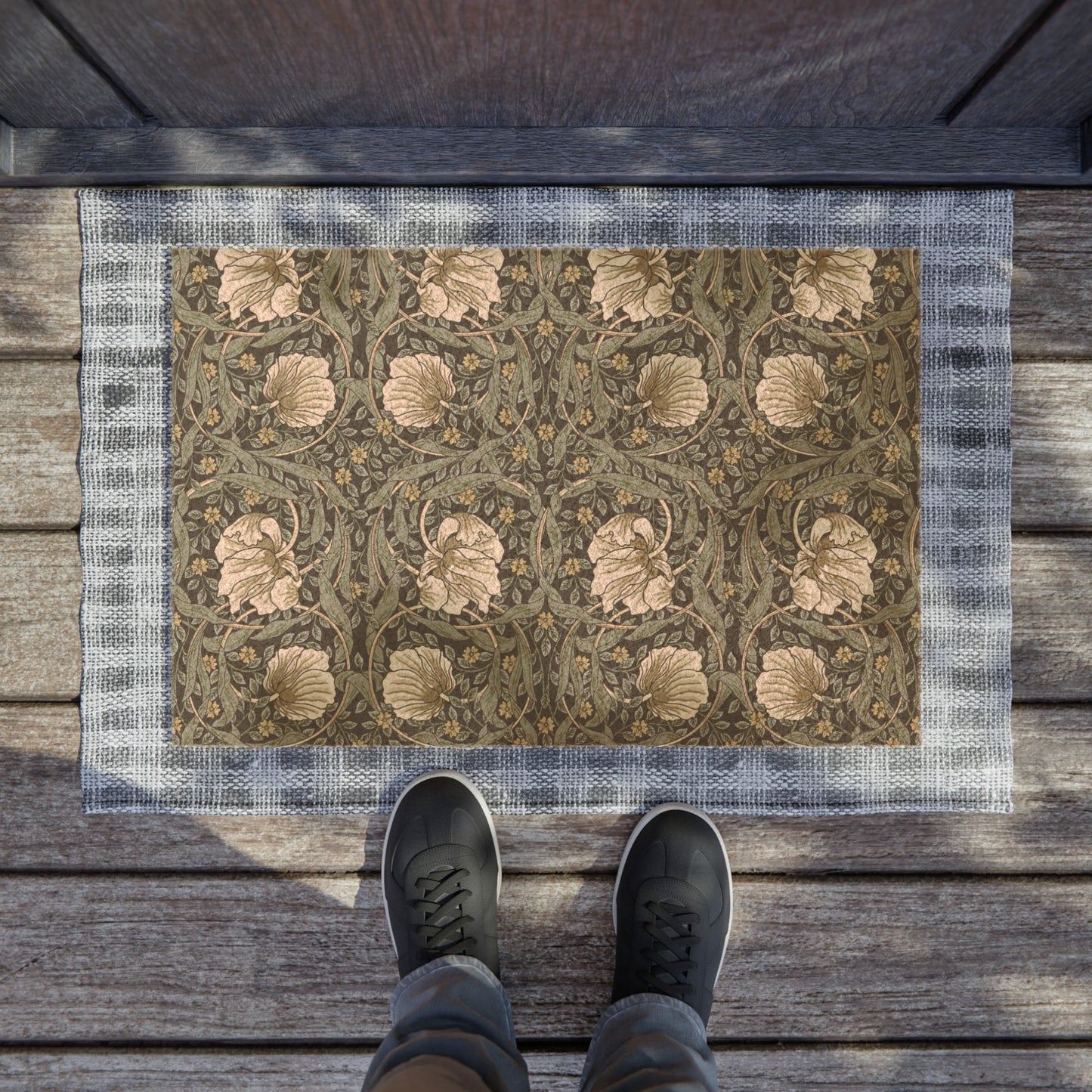 A rectangular doormat with a William Morris & Co floral pattern in shades of blue and beige, featuring tufted coir coconut fibre.