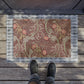 Rectangular William Morris-inspired coconut coir doormat with pink flowers and green foliage on a brown background.