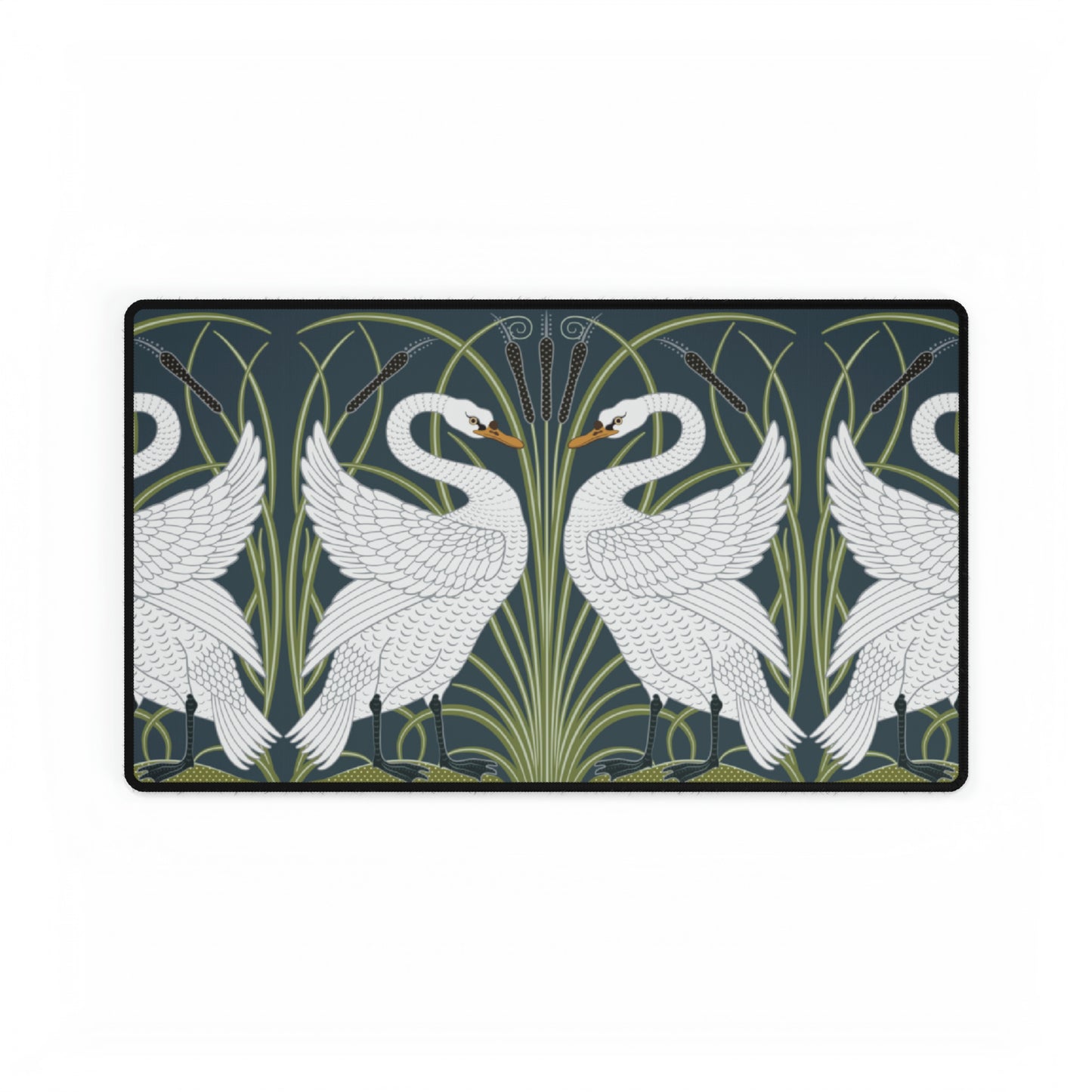 A rectangular desk mat with a floral and swan William Morris & Co pattern design, featuring a white background and swans, placed under a white mouse pad with a keyboard on top.