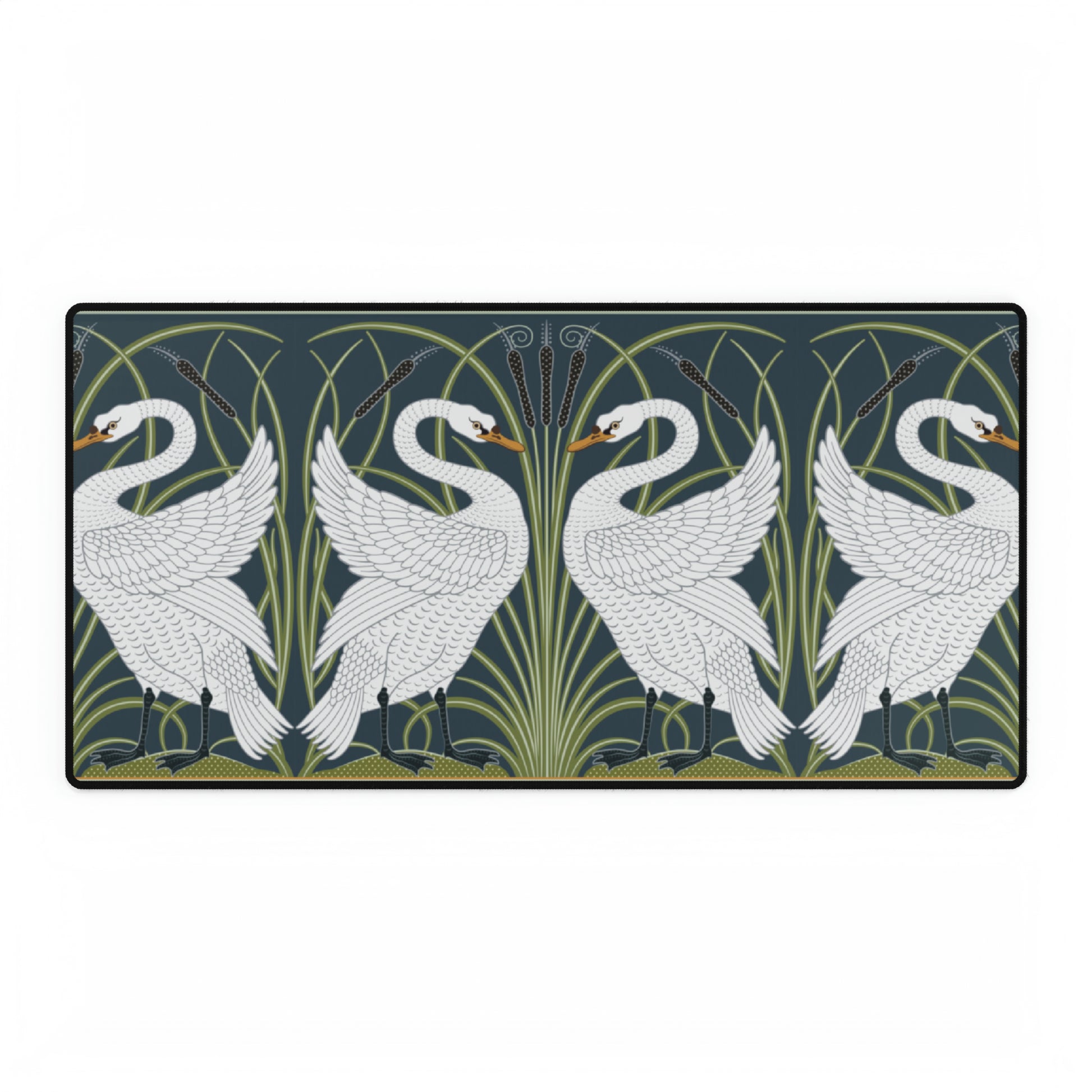 A rectangular desk mat with a floral and swan William Morris & Co pattern design, featuring a white background and swans, placed under a white mouse pad with a keyboard on top.