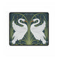 A rectangular desk mat with a floral and swan William Morris & Co pattern design, featuring a white background and swans, placed under a white mouse pad with a keyboard on top.