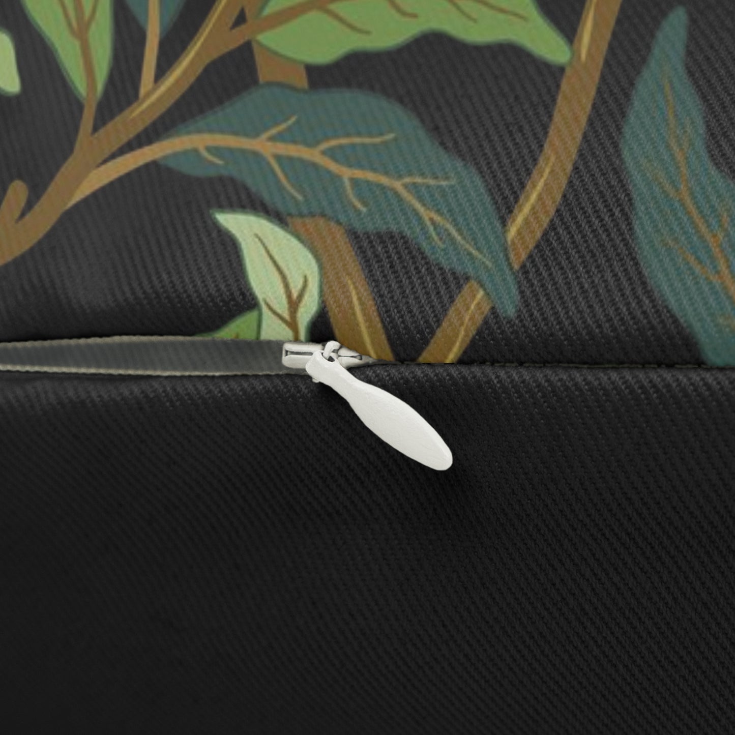 A rectangular William Morris & Co lumbar cushion with a bird and pomegranate design on a green background, featuring a concealed zipper.