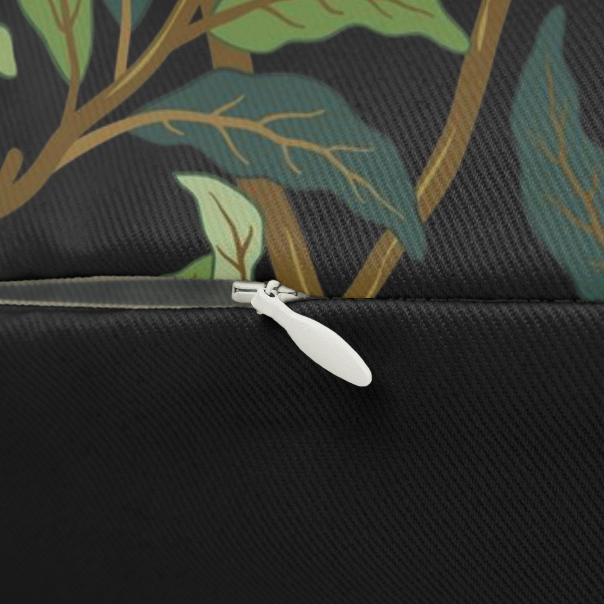 A rectangular William Morris & Co lumbar cushion with a bird and pomegranate design on a green background, featuring a concealed zipper.