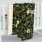 A Sherpa fleece blanket with a floral William Morris & Co pattern featuring birds and pomegranates, predominantly in green tones.