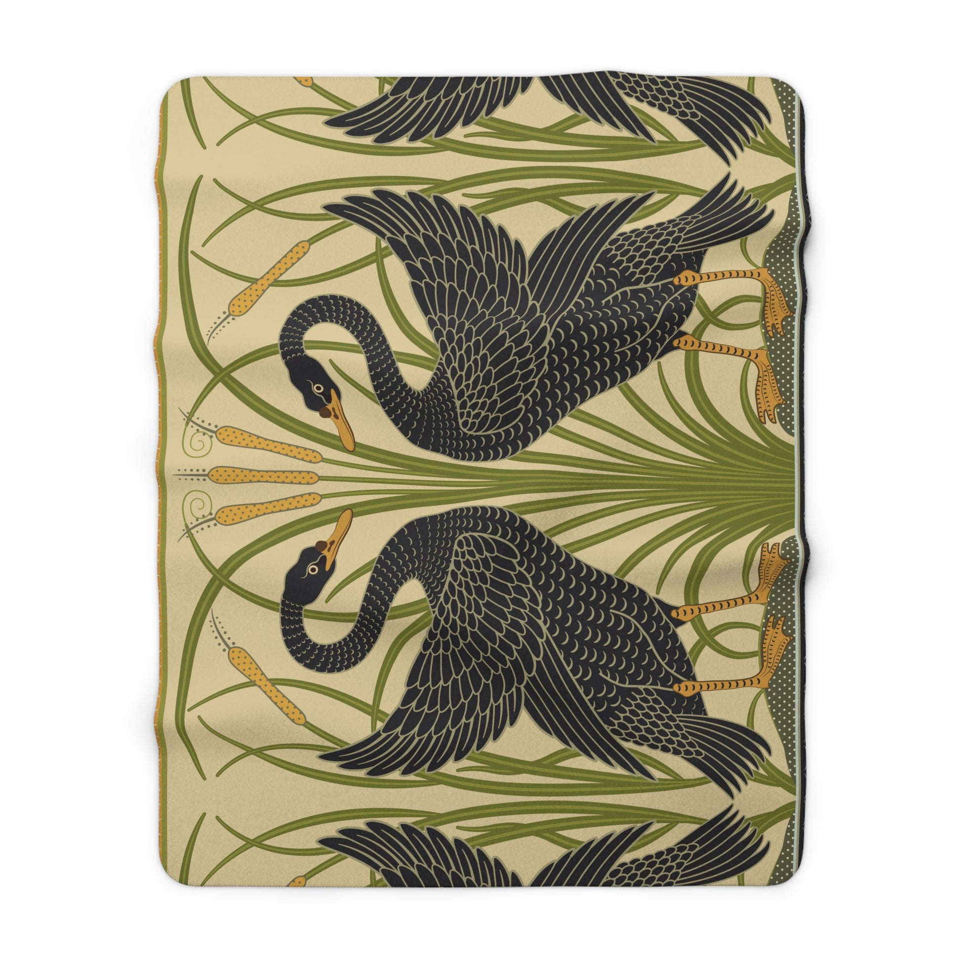 A Sherpa fleece blanket with a pattern inspired by William Morris, featuring black swans and green foliage on a beige background.