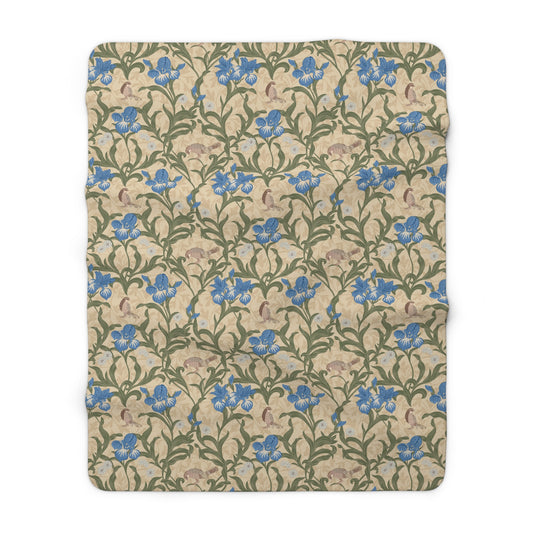 A Sherpa fleece blanket with a floral William Morris & Co pattern in blue and green on a beige background.