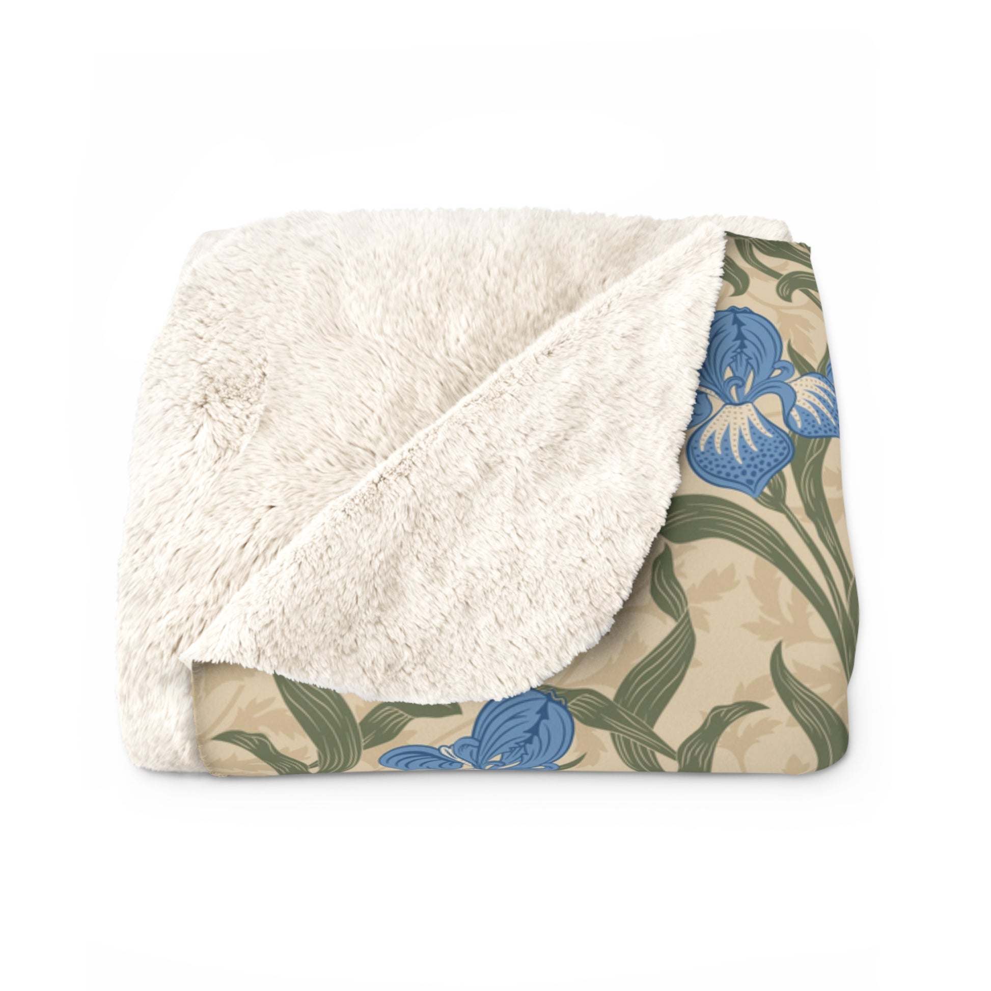 A Sherpa fleece blanket with a floral William Morris & Co pattern in blue and green on a beige background.