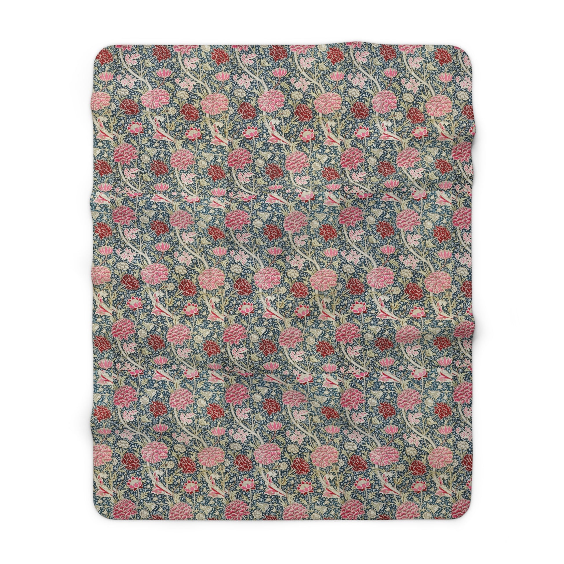 A cozy fluffy fleece blanket with a floral William Morris & Co pattern in various colours, laid flat.