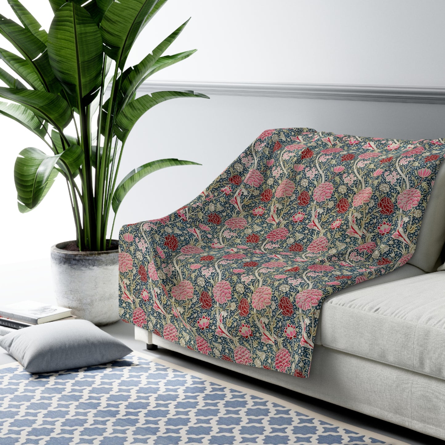 A cozy fluffy fleece blanket with a floral William Morris & Co pattern in various colours, laid flat.