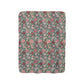 A cozy fluffy fleece blanket with a floral William Morris & Co pattern in various colours, laid flat.