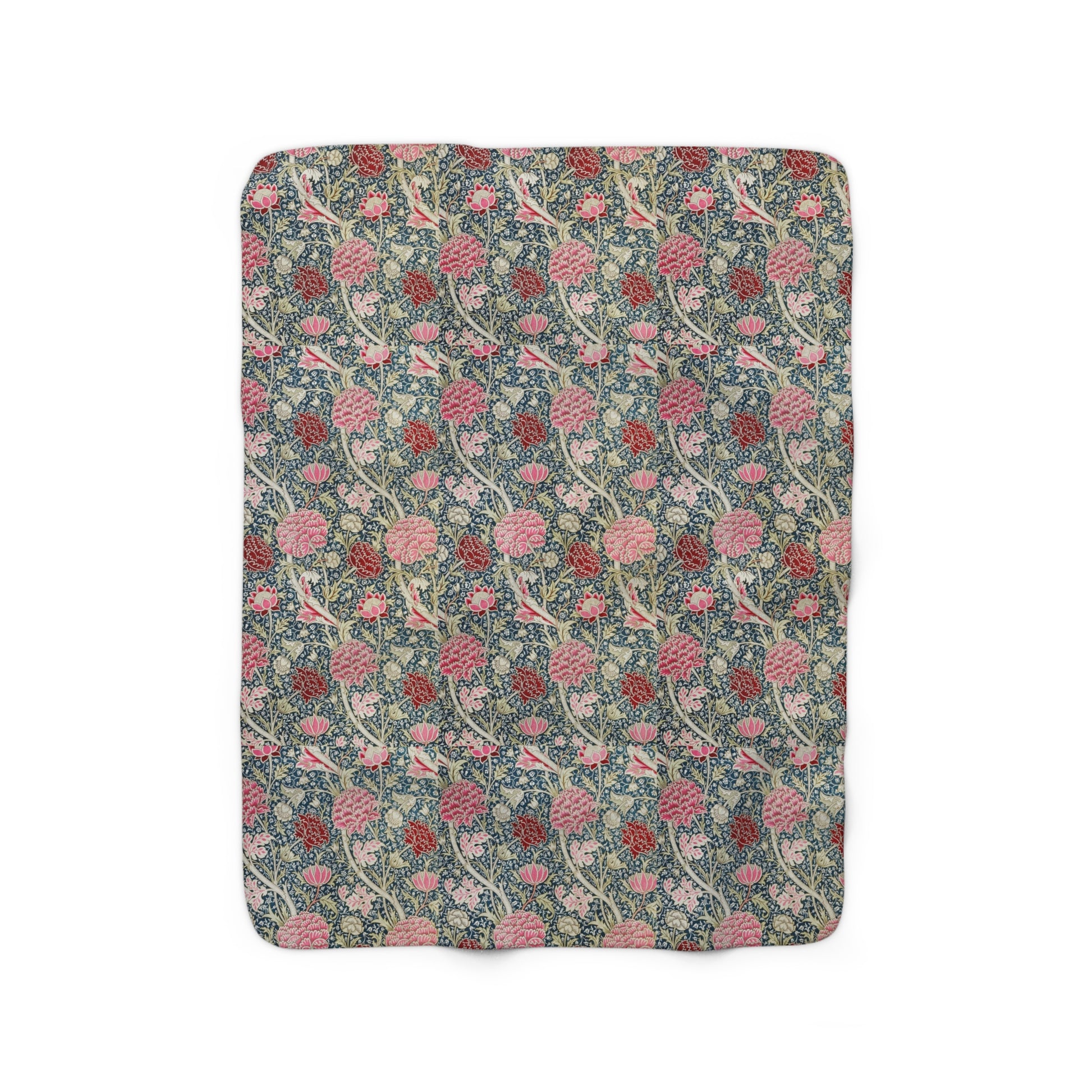A cozy fluffy fleece blanket with a floral William Morris & Co pattern in various colours, laid flat.