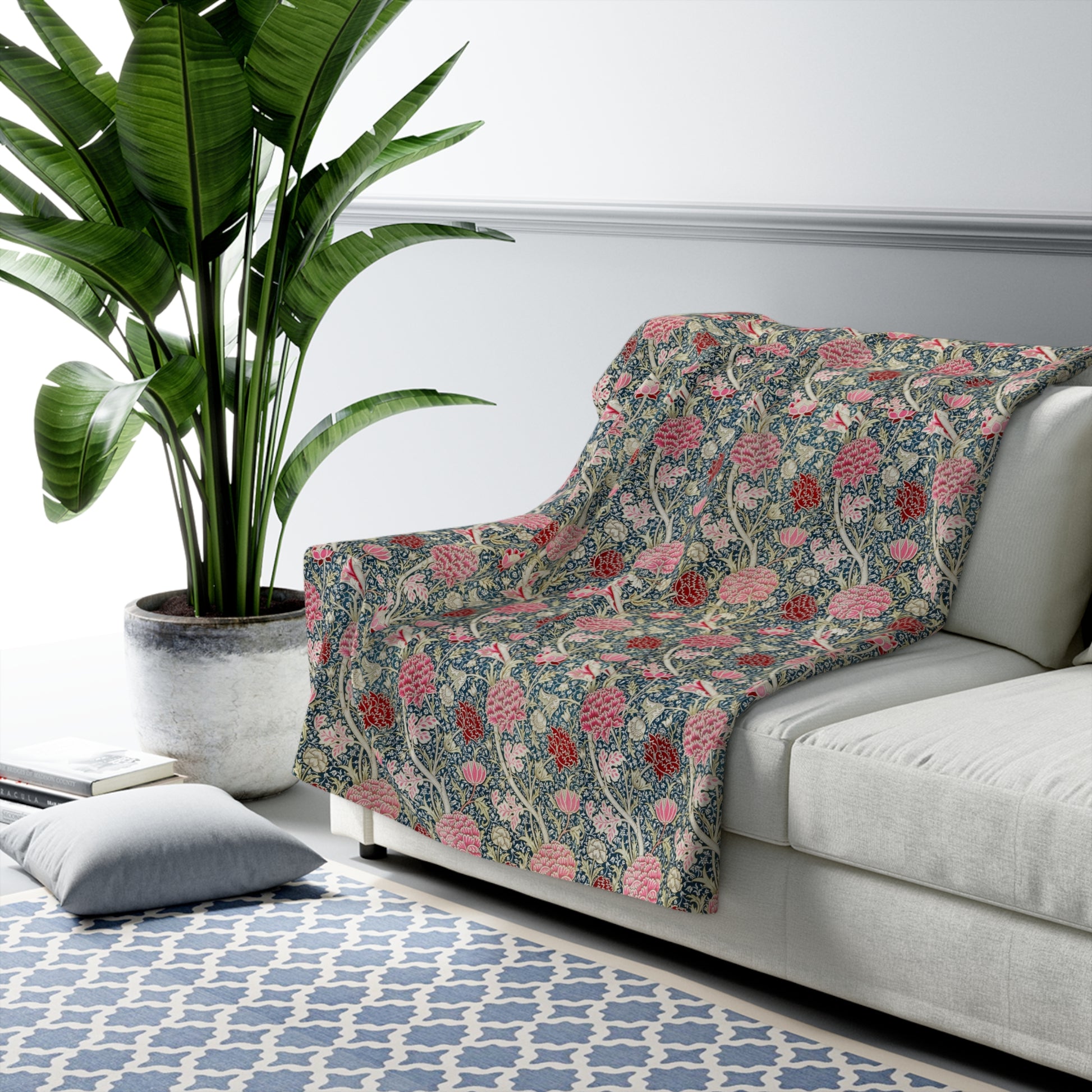 A cozy fluffy fleece blanket with a floral William Morris & Co pattern in various colours, laid flat.