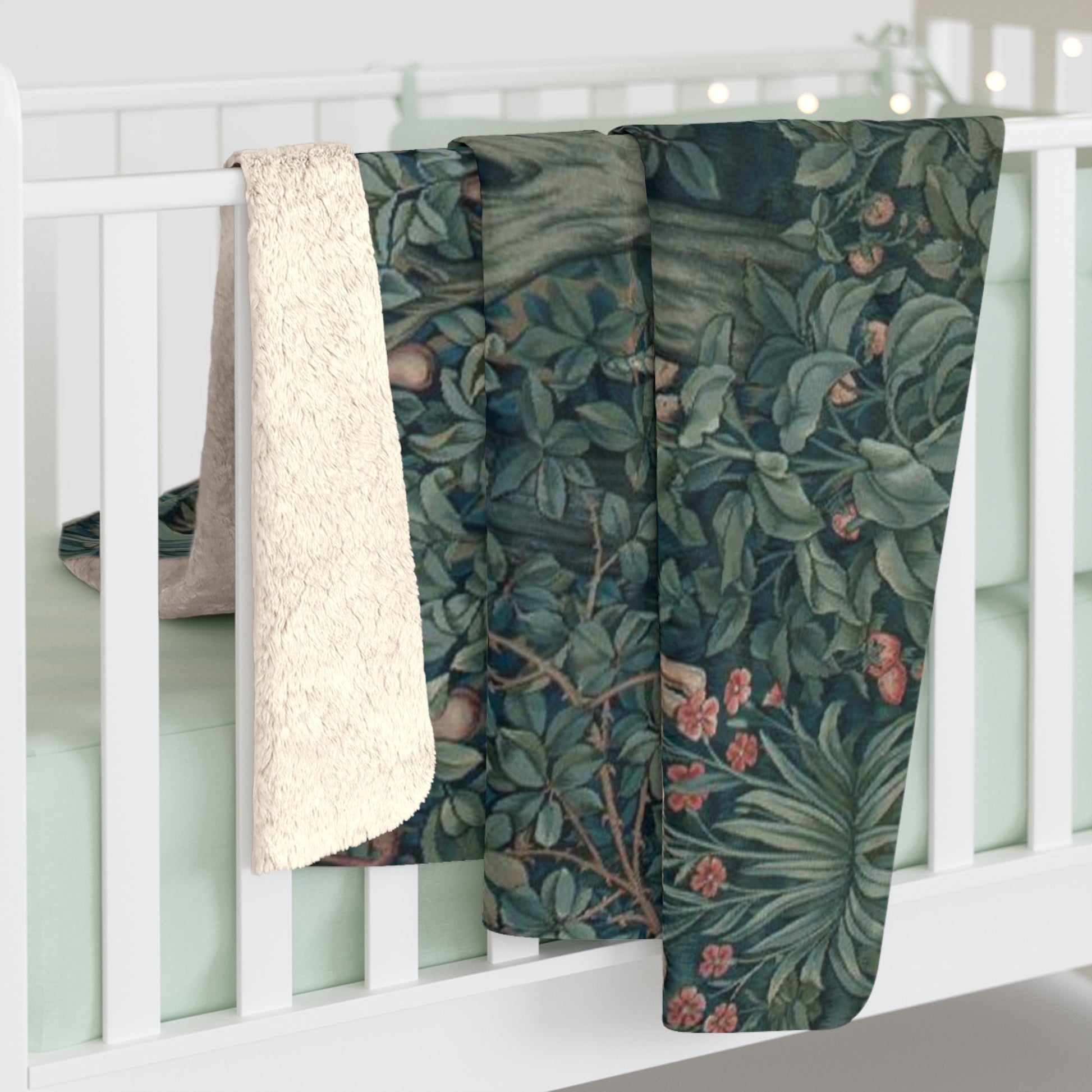 A Sherpa fleece blanket with an embossed design featuring rabbits, foxes, and green foliage on a green background.