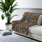 A Sherpa fleece blanket with a geometric and floral pattern in a multicolour William Morris & Co print.