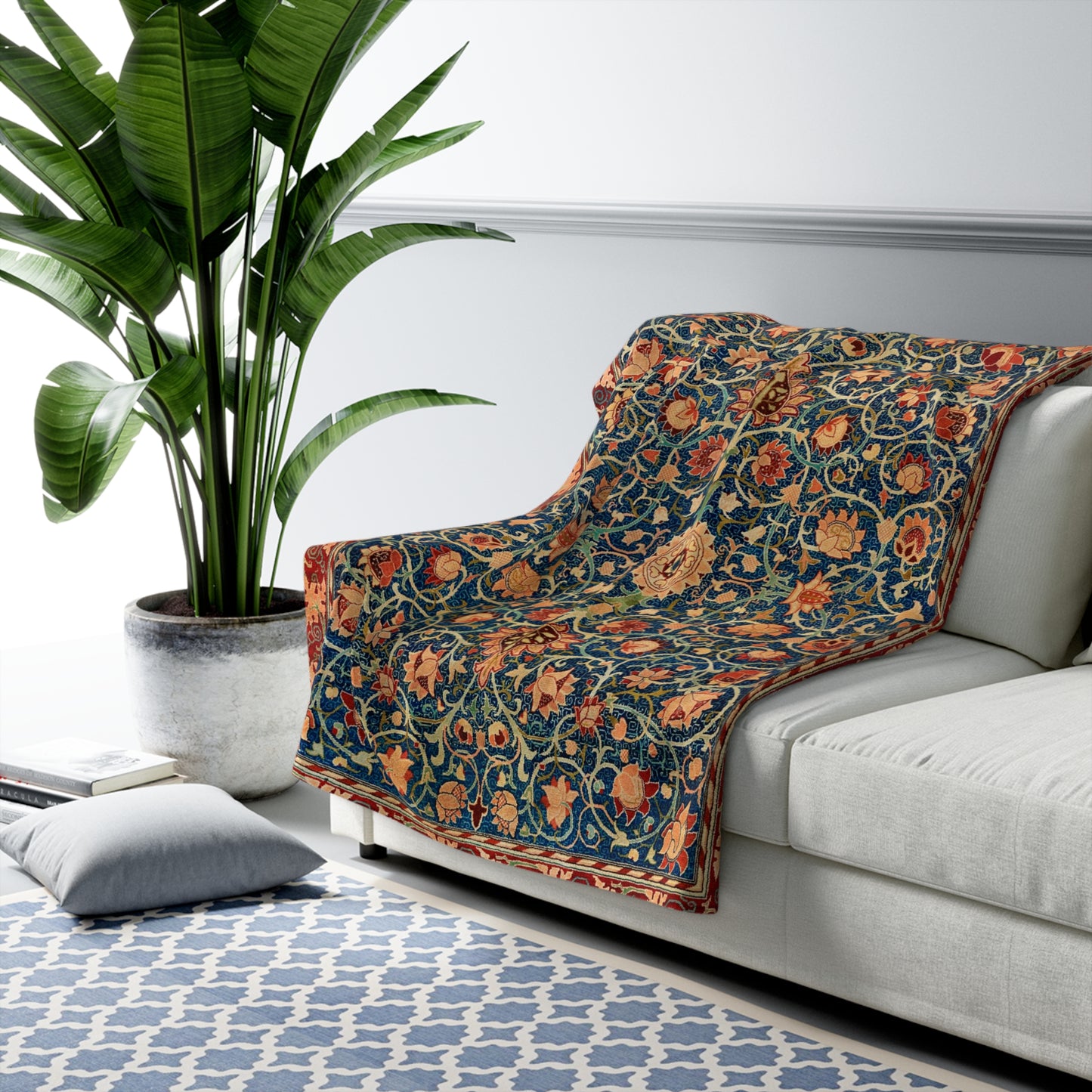 A Sherpa fleece blanket with a geometric and floral pattern in a multicolour William Morris & Co print.