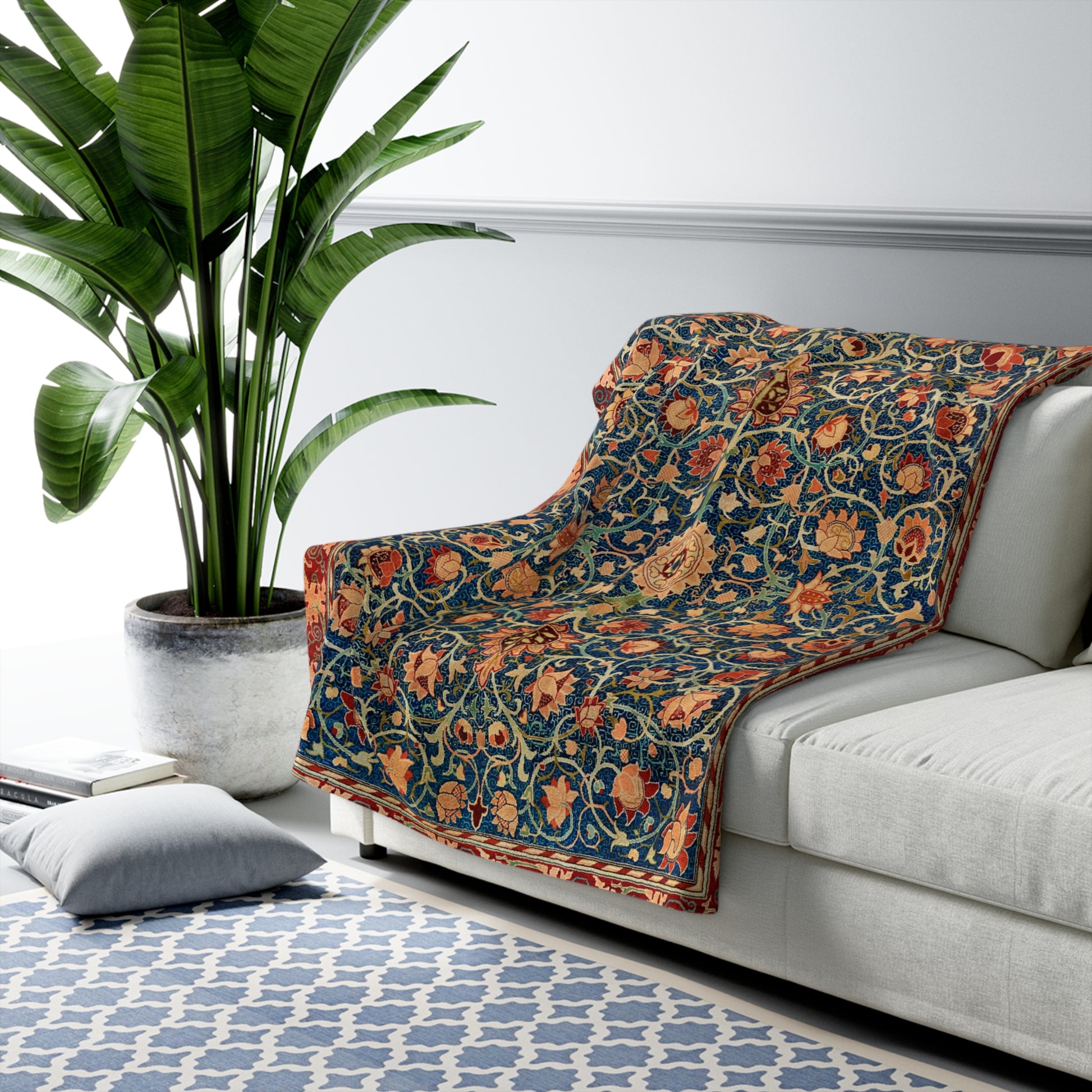A Sherpa fleece blanket with a geometric and floral pattern in a multicolour William Morris & Co print.