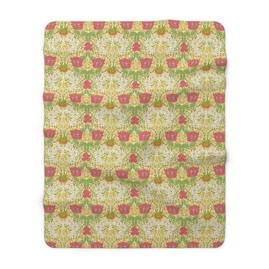 A Sherpa fleece blanket with a floral pattern in pink and yellow hues on a green background, displayed flat.