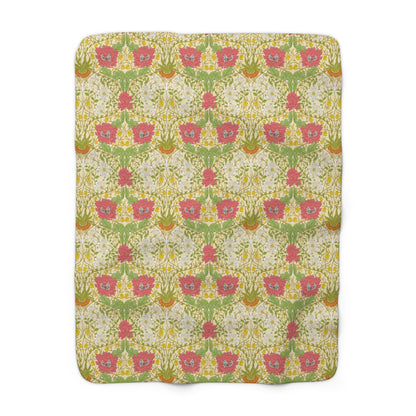 A Sherpa fleece blanket with a floral pattern in pink and yellow hues on a green background, displayed flat.
