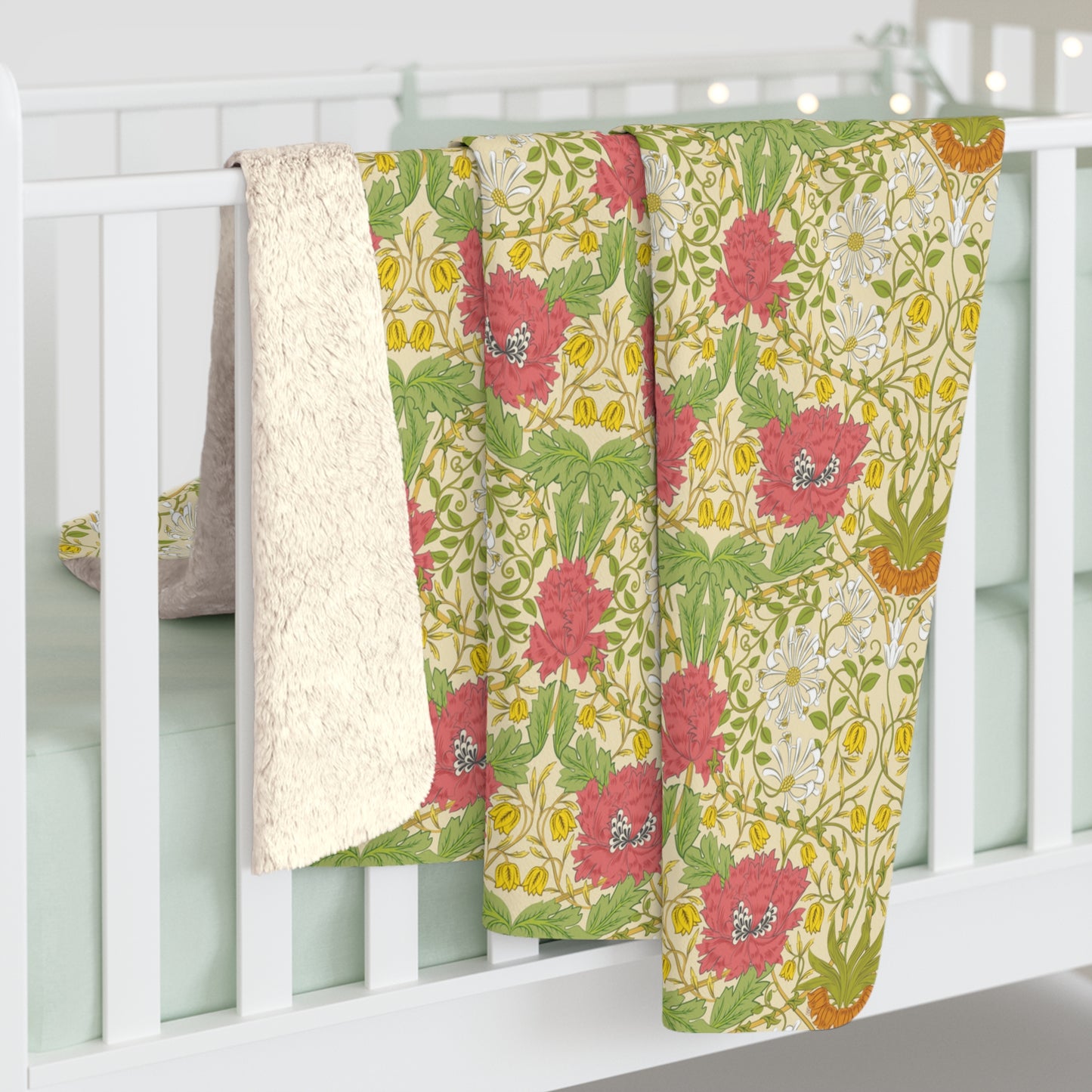 A Sherpa fleece blanket with a floral pattern in pink and yellow hues on a green background, displayed flat.