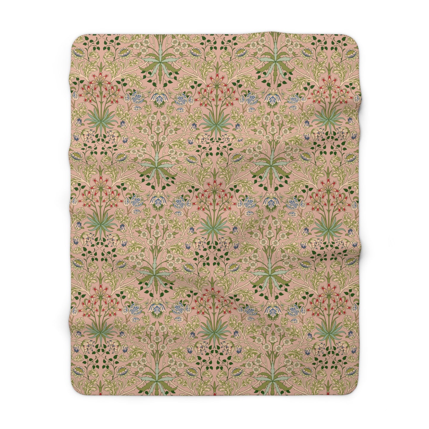 A Sherpa fleece blanket with a floral pattern in pink, green and beige colours on a pink background.