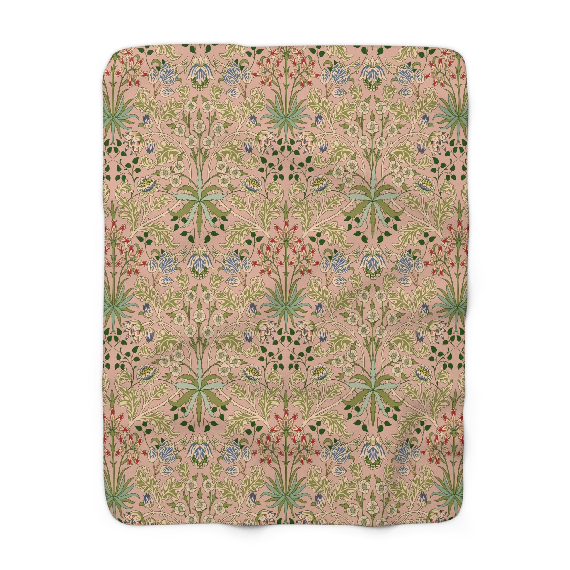 A Sherpa fleece blanket with a floral pattern in pink, green and beige colours on a pink background.