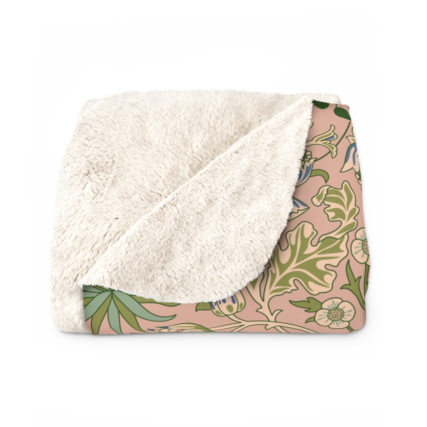 A Sherpa fleece blanket with a floral pattern in pink, green and beige colours on a pink background.