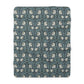 A plush fleece blanket with a geometric William Morris & Co pattern in a slate blue colour, featuring a dense, cozy texture.