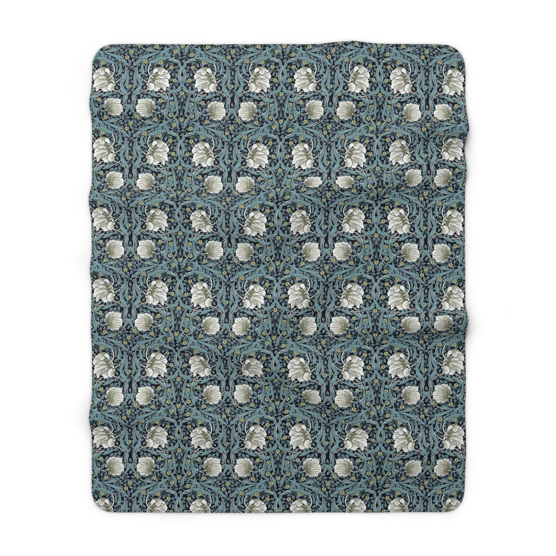 A plush fleece blanket with a geometric William Morris & Co pattern in a slate blue colour, featuring a dense, cozy texture.